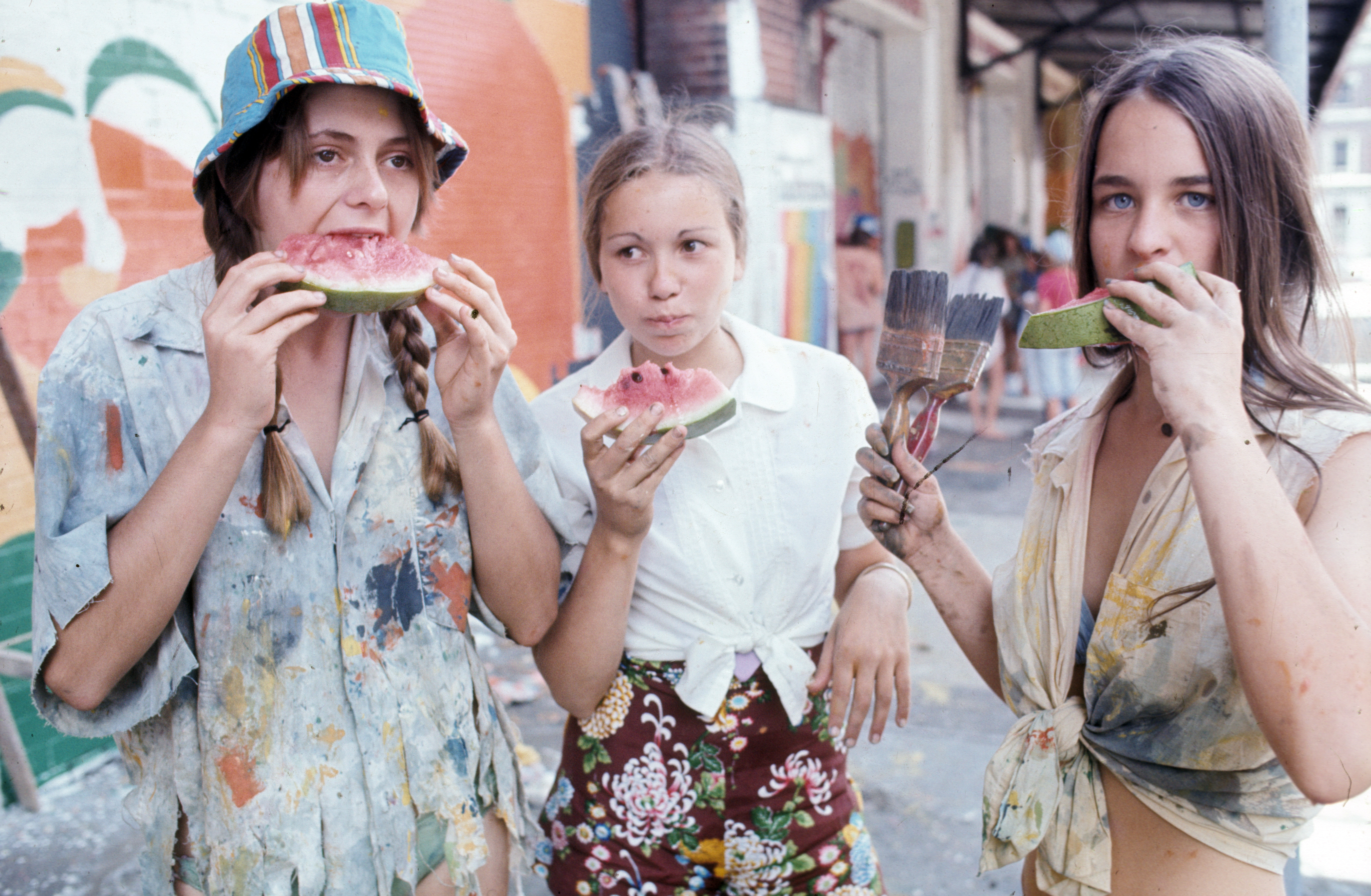 Art and summer in harmony, as these young women take a watermelon break whilst painting